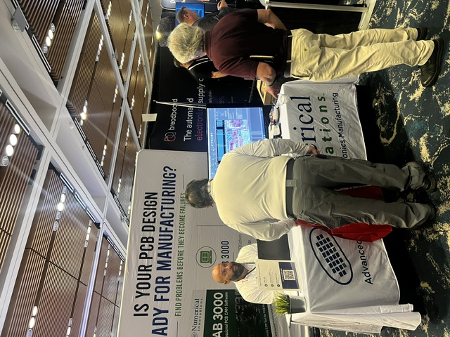 Visitors viewing a FAB 3000 demo at the Numerical Innovations booth